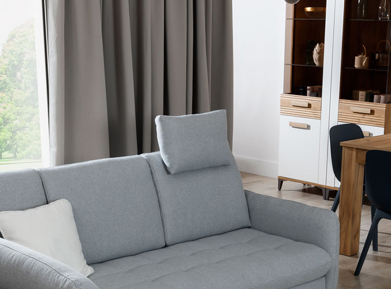 The LUKAS corner sofa bed in a modern living room presenting a headrest.