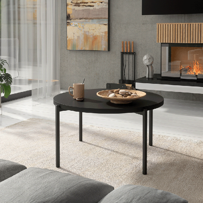 The coffee table SONIA C in black matt in a cosy living room.