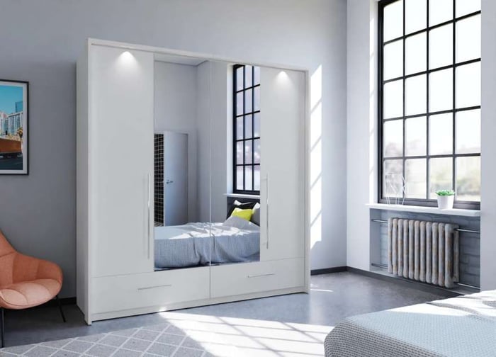 The bi-folding door TOLEDO 210cm Wardrobe white with mirrored doors and LED lights in a cosy bedroom.