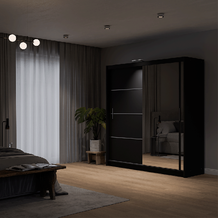The sliding door VISTA 180cm black displaying the LED in a cosy bedroom.