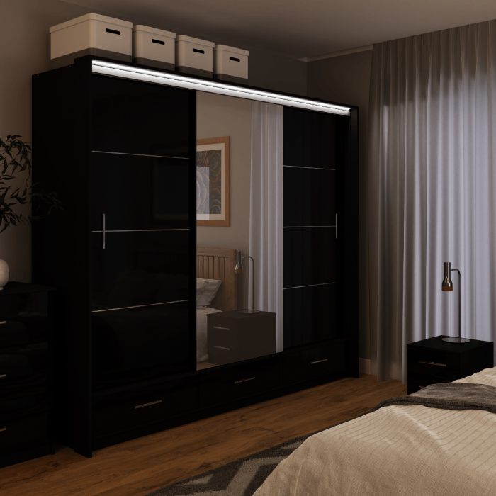 The sliding door wardrobe MARSYLIA 255cm black with mirrored door with LED lighting in a bedroom.