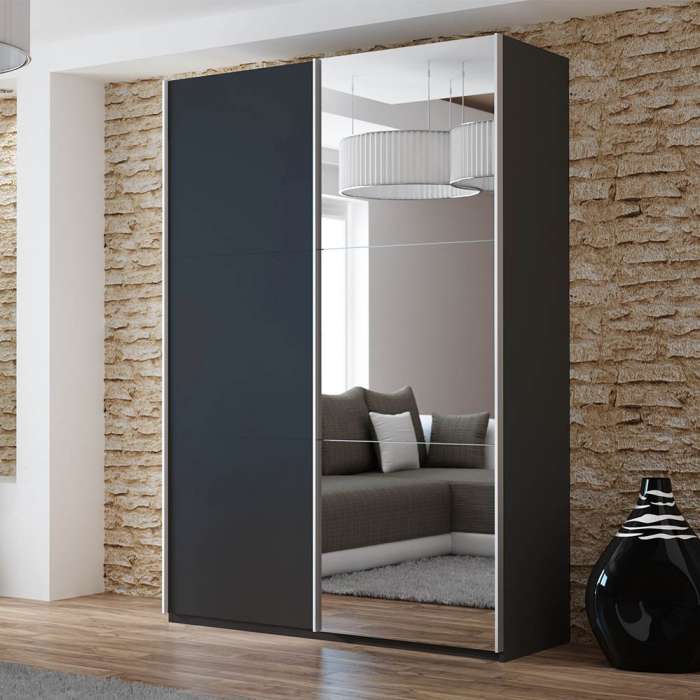 The sliding door wardrobe VIGO 150cm black with mirrored door in a room.