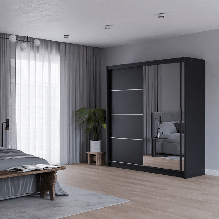 The sliding door VISTA 203cm black with mirrored door in a cosy bedroom.
