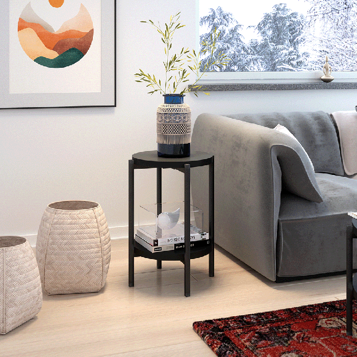 The SONIA coffee table D with the double-tier storage design in black matt in a modern living room.