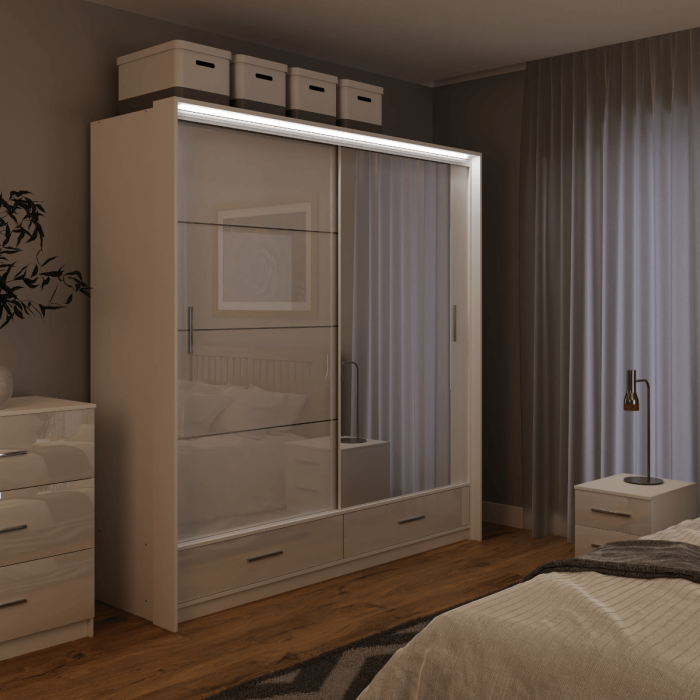 The sliding door wardrobe MARSYLIA 208cm white with mirrored door with LED lighting in a bedroom.