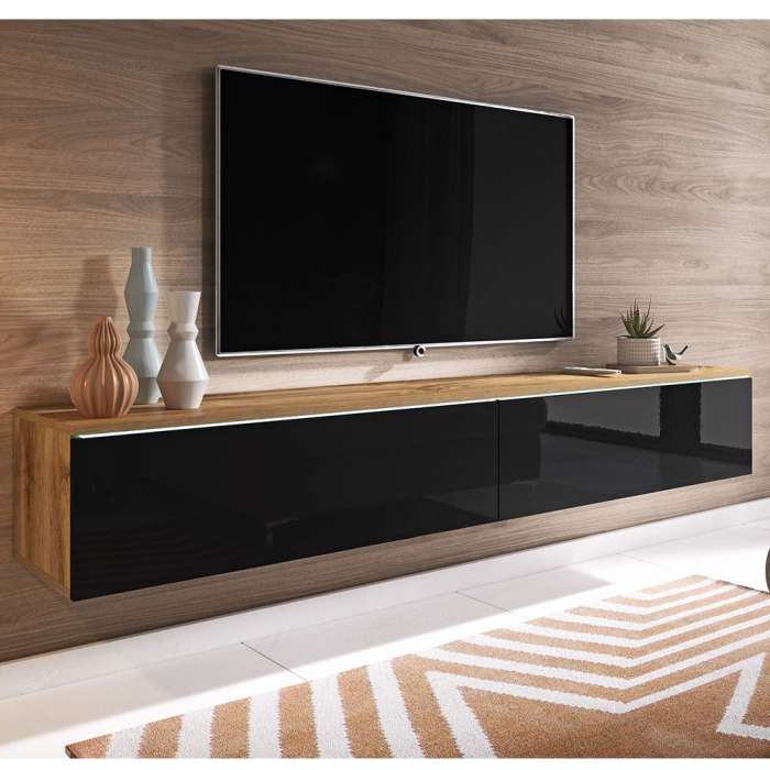 The TV unit DAISY 180 wotan with black glossy fronts in a modern living room.