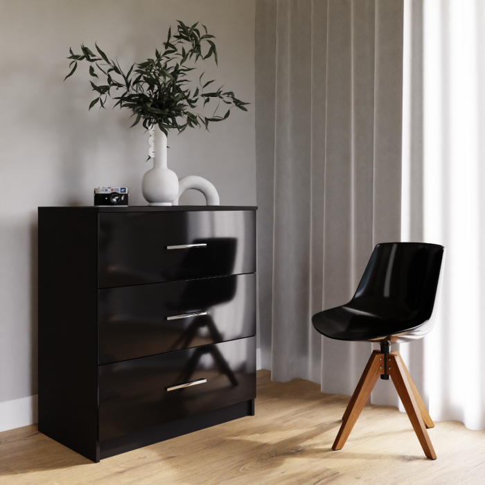 The black MARSYLIA chest of drawers in a cosy living room.