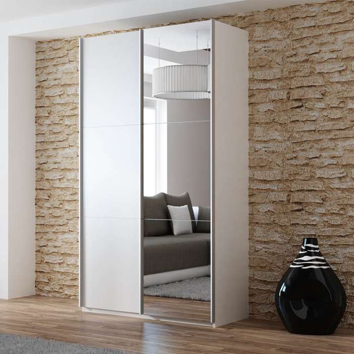 The sliding door wardrobe VIGO 120cm white with mirrored door in a room.