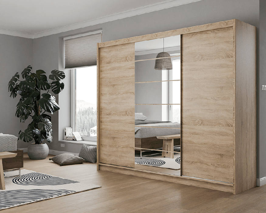 The sliding door wardrobe MALIBU oak sonoma with mirror in a cosy bedroom.