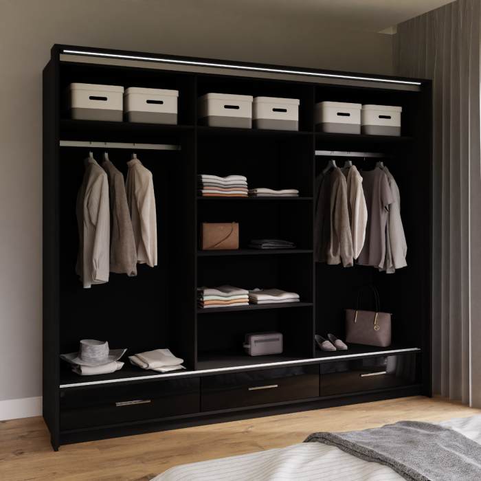 The interior of the MARSYLIA wardrobe presenting 2 hanging rails and 3 shelves and 3 drawers in a nice bedroom.