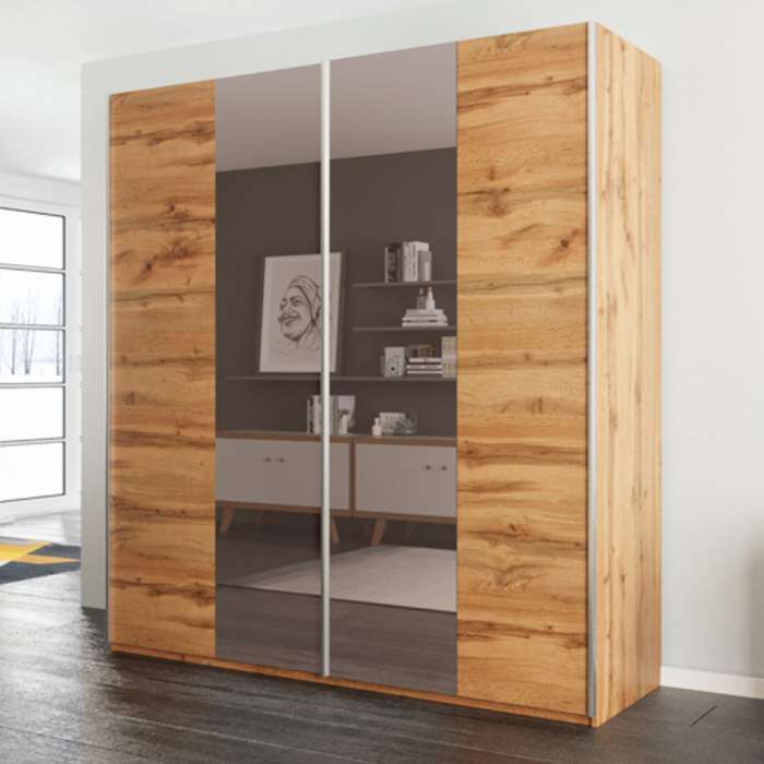 The sliding door wardrobe PRAGA 200cm oak wotan with mirrored doors in a bedroom.