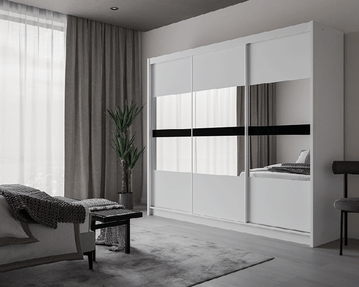 The sliding door wardrobe BATUMI 250cm white with mirrored doors in a cosy bedroom.