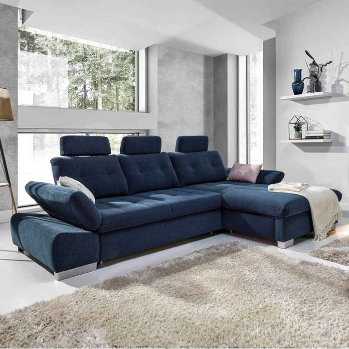 Corner sofa bed CALAMO 2 in a cosy living room showing adjustable armrest
