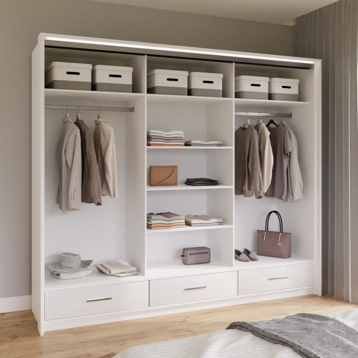 The interior of the MARSYLIA wardrobe presenting 2 hanging rails and 3 shelves and 3 drawers in a nice bedroom.