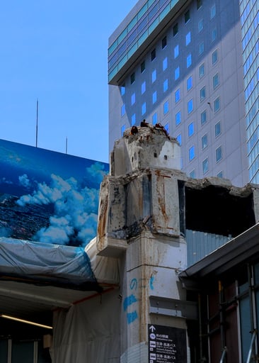 artificial clouds on a blue sky beyond a ruined column