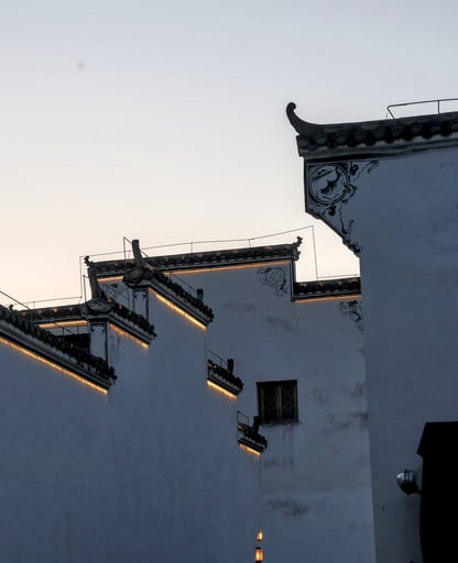 these traditional white walls have strips that light up as the sun sets