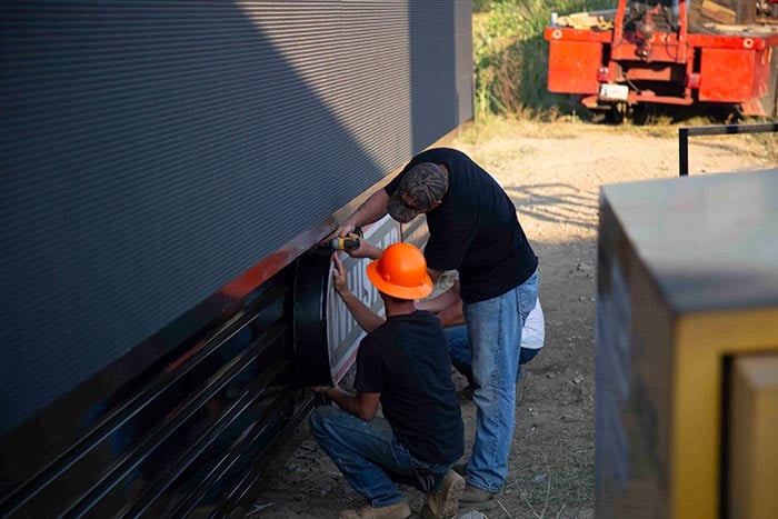 installing Whistler Billboard's logo on the billboard structure before lifting onto structure