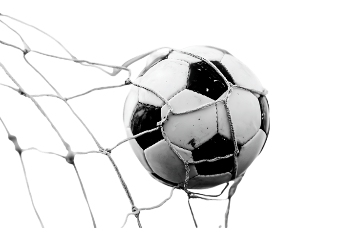 Close up of a soccer ball in the net. Black and white image.