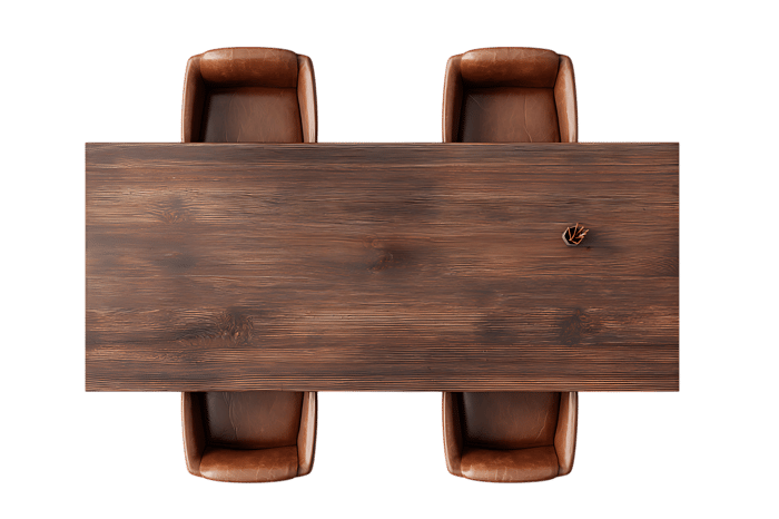 Overhead shot of a rustic wooden table with four brown leather chairs.