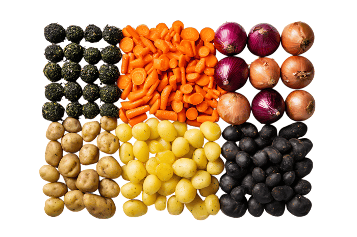 Flat lay of assorted vegetables,  carrots, potatoes, onions, and olives.