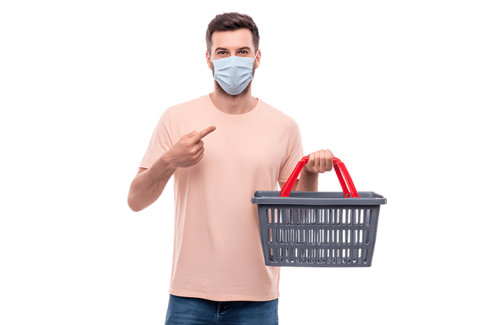 Caucasian man in mask holds shopping basket.