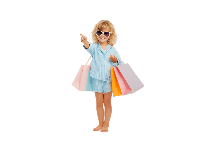 Happy child with shopping bags, pointing. Ideal for retail, shopping, and kids' fashion.