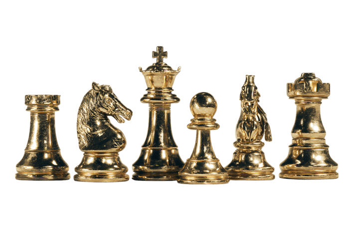 Close up of golden chess pieces on black background