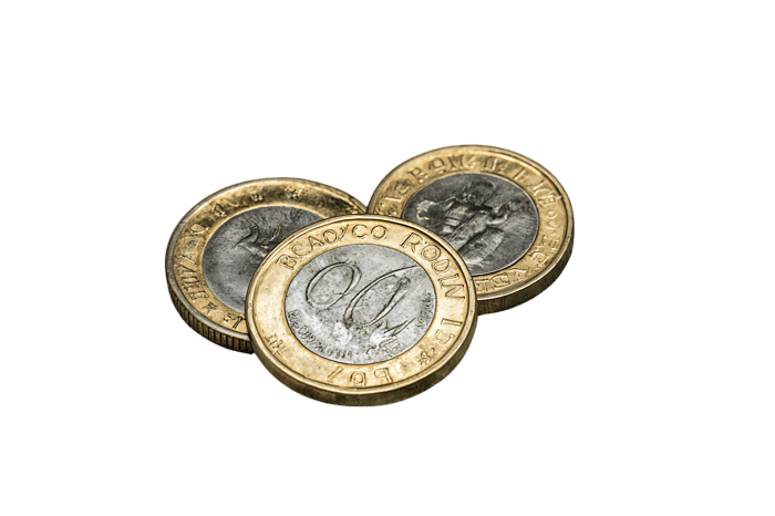 Three British one pound coins close up.