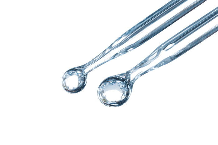 Close up of two clear plastic spoons.