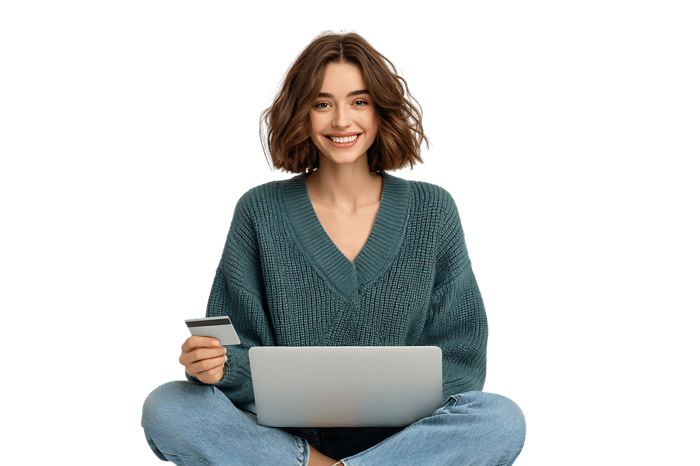 Smiling woman using laptop and credit card for online shopping.