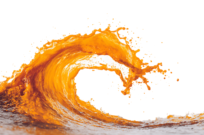 Dynamic splash of orange juice forming a wave.