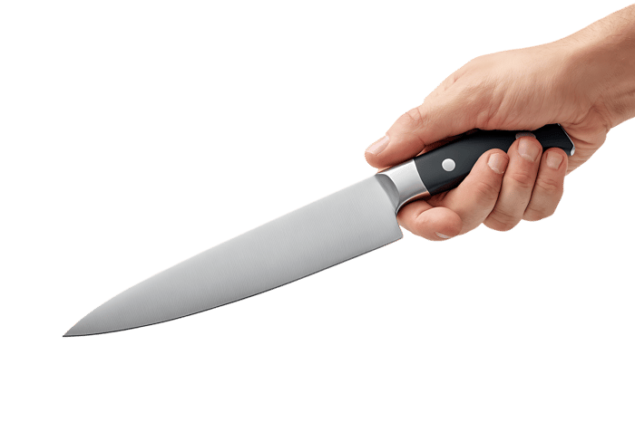 Chef's hand grips a sharp kitchen knife.