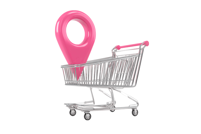 Pink location pin in shopping cart. Online shopping, delivery, location based services concept.