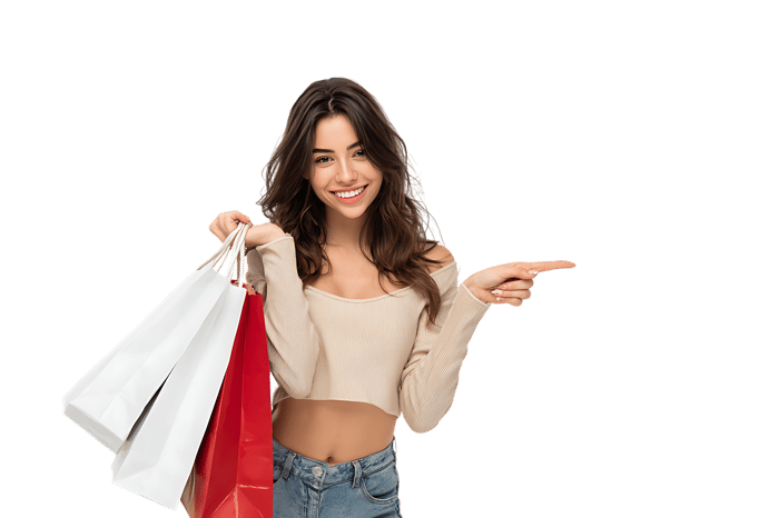 Happy woman with shopping bags, pointing to the side.