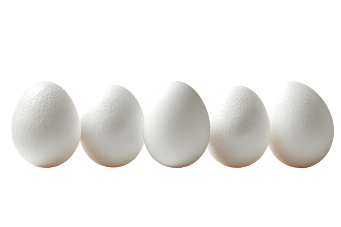 Five fresh white chicken eggs arranged in a neat row on a plain background, symbolizing uniformity and purity