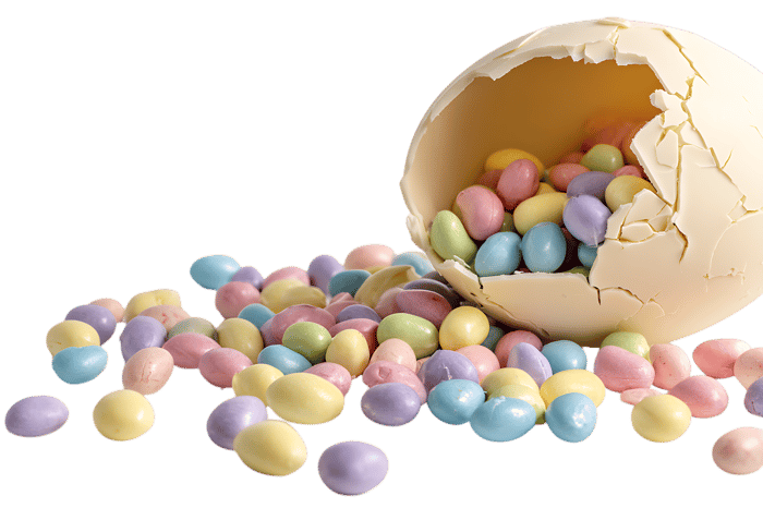 Pastel candies spill from a cracked chocolate egg.