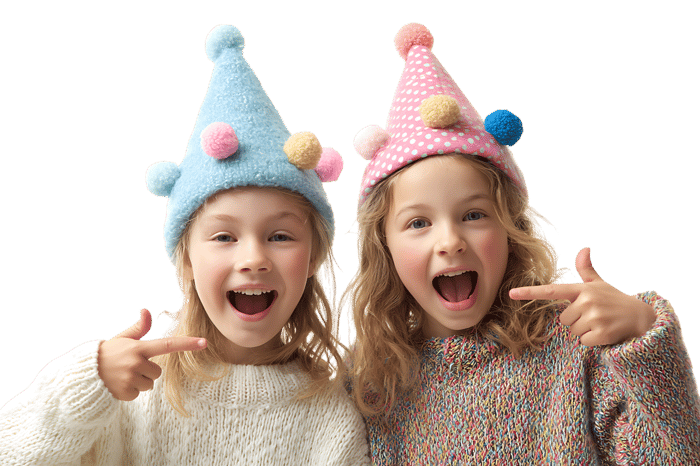 Two smiling girls in party hats