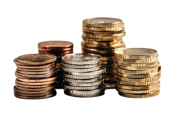 Close up of various coins stacked high, illustrating wealth, finance, or savings.