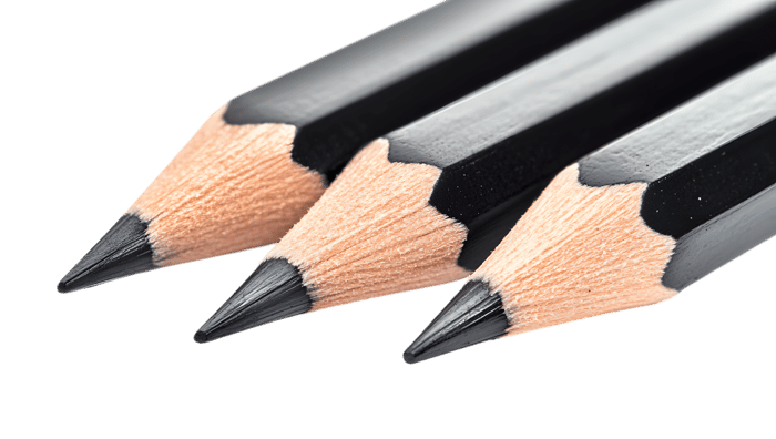 Three sharpened graphite pencils, close up view.  Texture, detail, and art supplies.