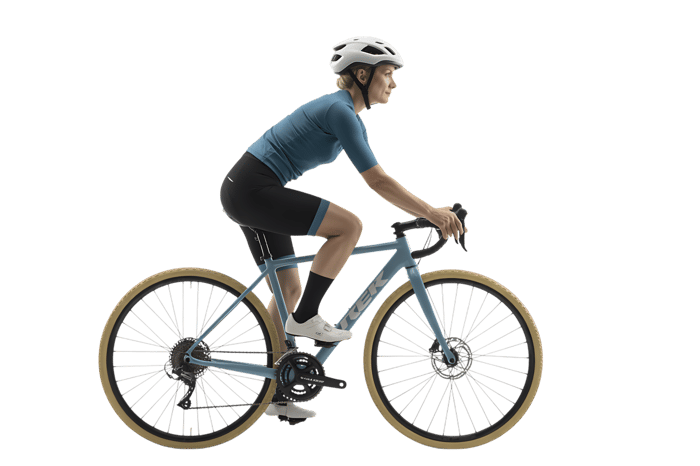 Female cyclist riding a blue gravel bike