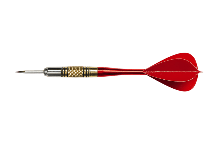 Close up of a single red dart isolated on black.