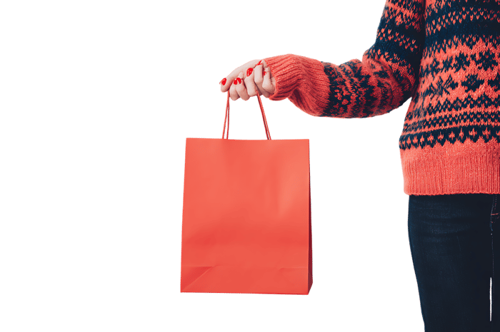 Person holding a coral shopping bag.