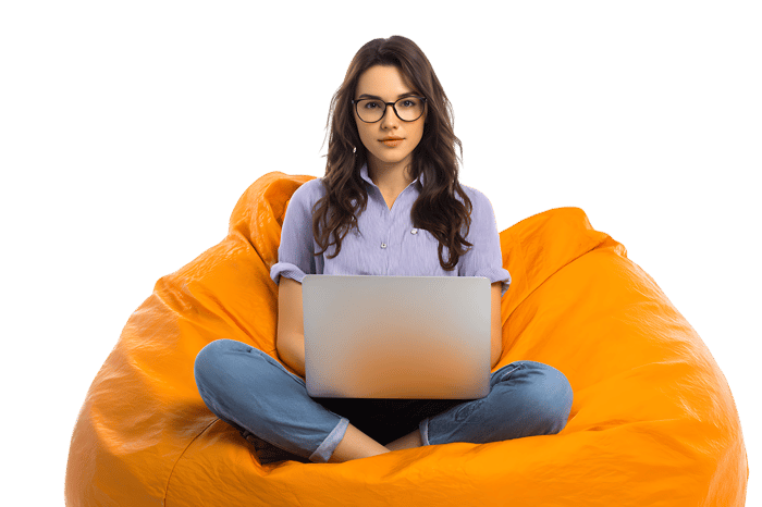 Young woman using laptop relaxing in orange bean bag chair