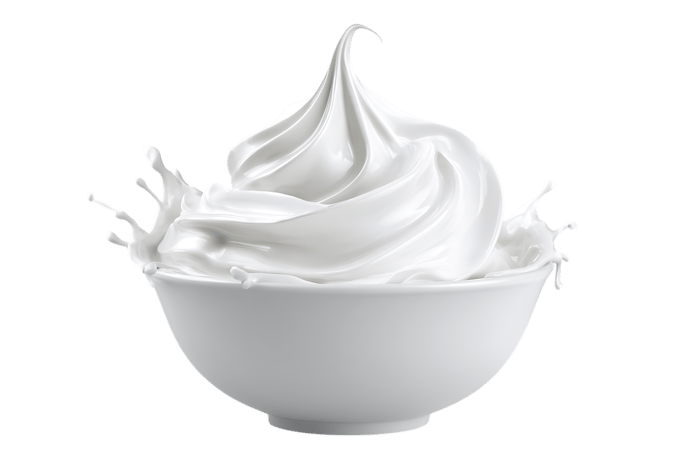 Fresh white whipped cream dollop in ceramic bowl, isolated on white background