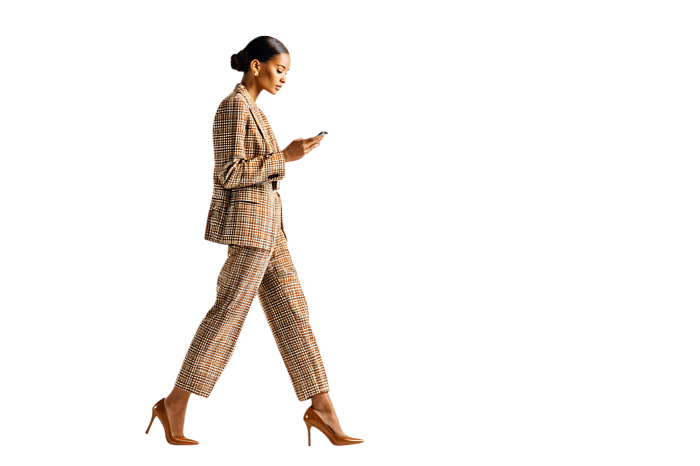 Businesswoman walking and using smartphone