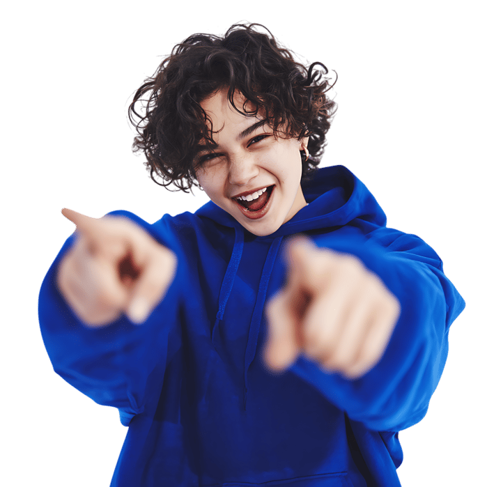 Happy, playful boy pointing towards camera, expressing excitement.