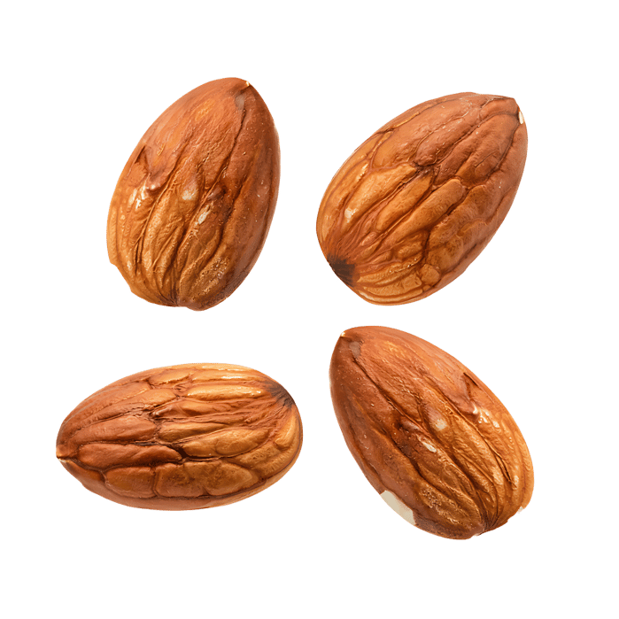 Four almonds on a white background. Healthy food, nuts.