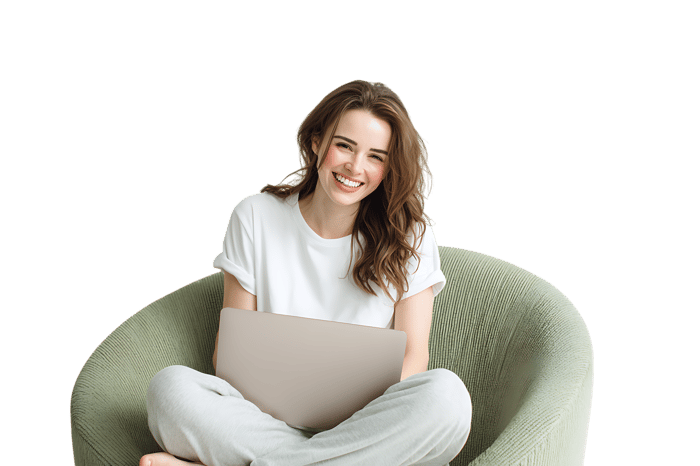 Smiling woman using laptop in comfy armchair.