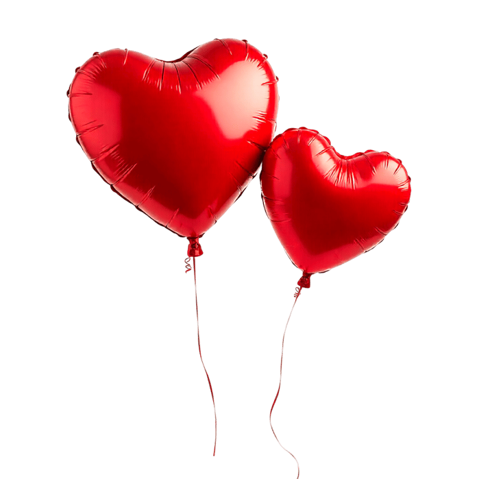 Two red heart balloons floating in the air