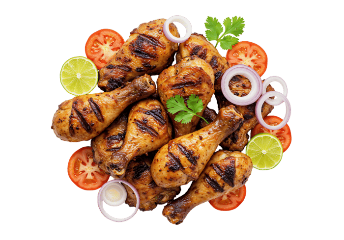 Delicious grilled chicken legs with tomatoes, onions, and lime.